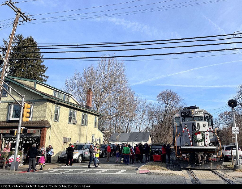 The DRRV Toys for Tots Train is resting in Downtown Rockaway while a jubilant crowd of people partake in the holiday festivities